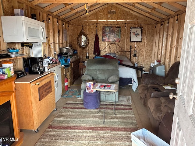 misc room featuring wooden walls and vaulted ceiling