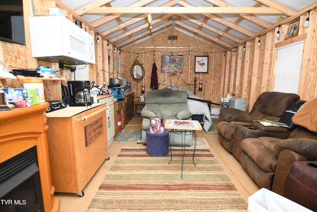 living room with wooden walls and vaulted ceiling with beams