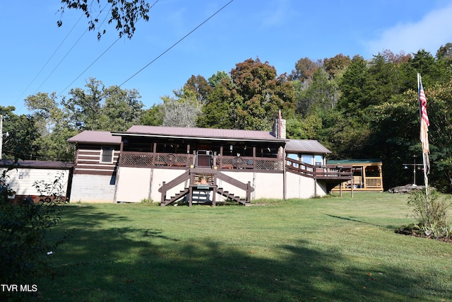 back of house with a lawn and a deck