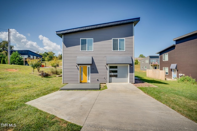 rear view of property with a lawn and a garage