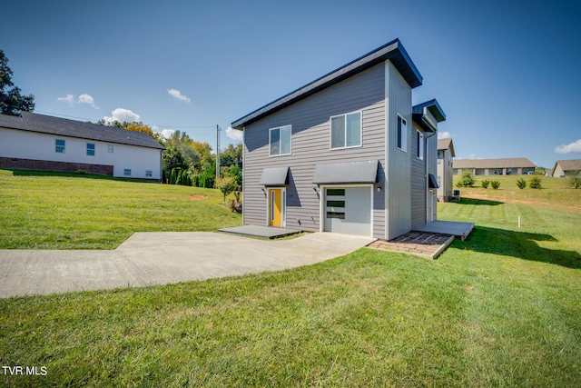 view of front of home featuring a front lawn and a patio