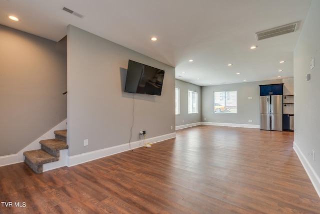 unfurnished living room with dark hardwood / wood-style floors