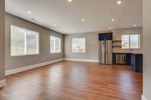 unfurnished living room with dark wood-type flooring