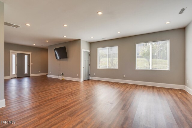 unfurnished living room featuring dark hardwood / wood-style flooring