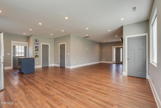 unfurnished living room featuring hardwood / wood-style flooring