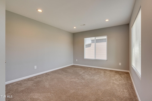 unfurnished room featuring light colored carpet