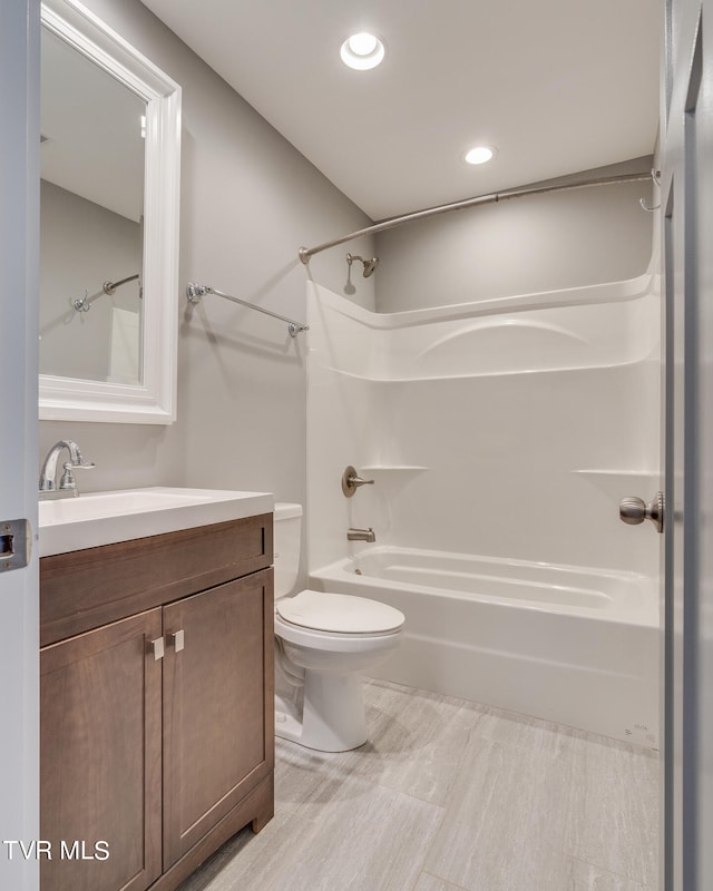 full bathroom featuring vanity, toilet, and  shower combination