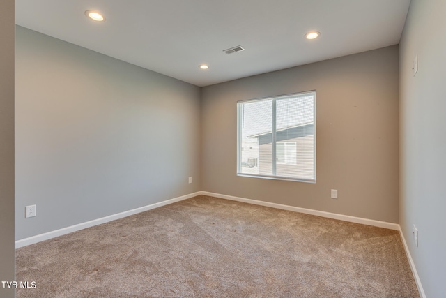 empty room featuring light colored carpet