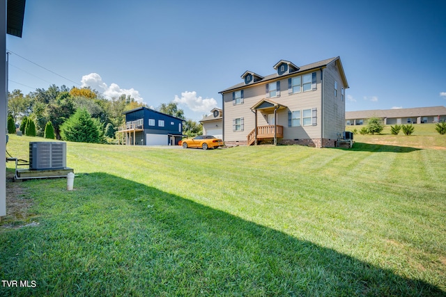 view of yard featuring a deck, central air condition unit, and a garage