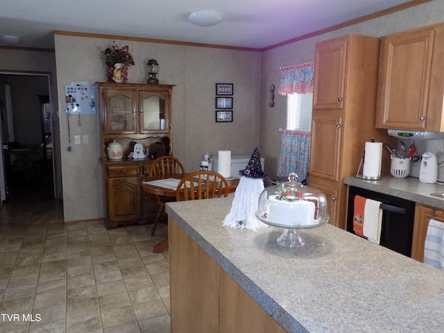 kitchen featuring black dishwasher and crown molding