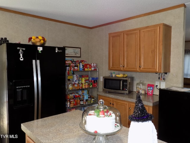 kitchen with ornamental molding, a textured ceiling, and black fridge with ice dispenser