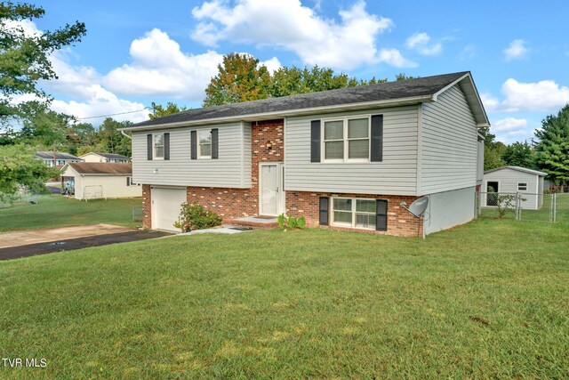 split foyer home featuring a front yard and a garage