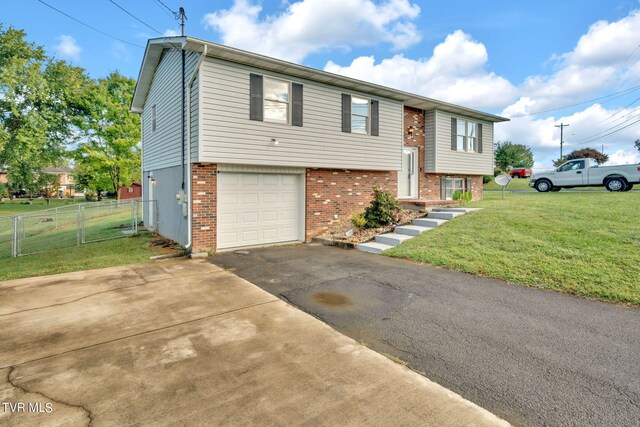 bi-level home featuring a front yard and a garage