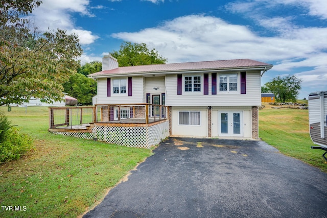 bi-level home featuring french doors, a deck, and a front lawn