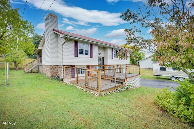 view of front of home with a front yard and a wooden deck