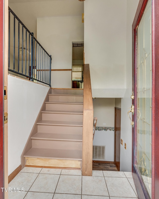 stairs featuring tile patterned floors