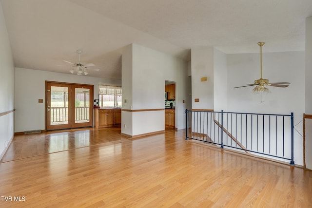 unfurnished room with vaulted ceiling, ceiling fan, and light hardwood / wood-style flooring