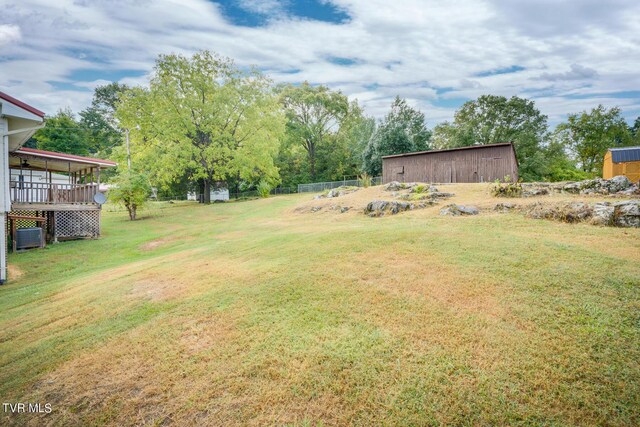 view of yard featuring an outdoor structure and central air condition unit