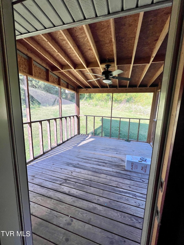 deck with ceiling fan, a yard, and a porch