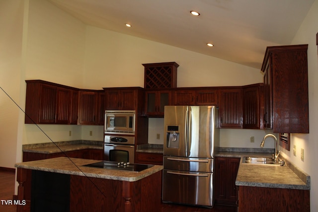 kitchen featuring dark wood-type flooring, sink, stainless steel appliances, and lofted ceiling