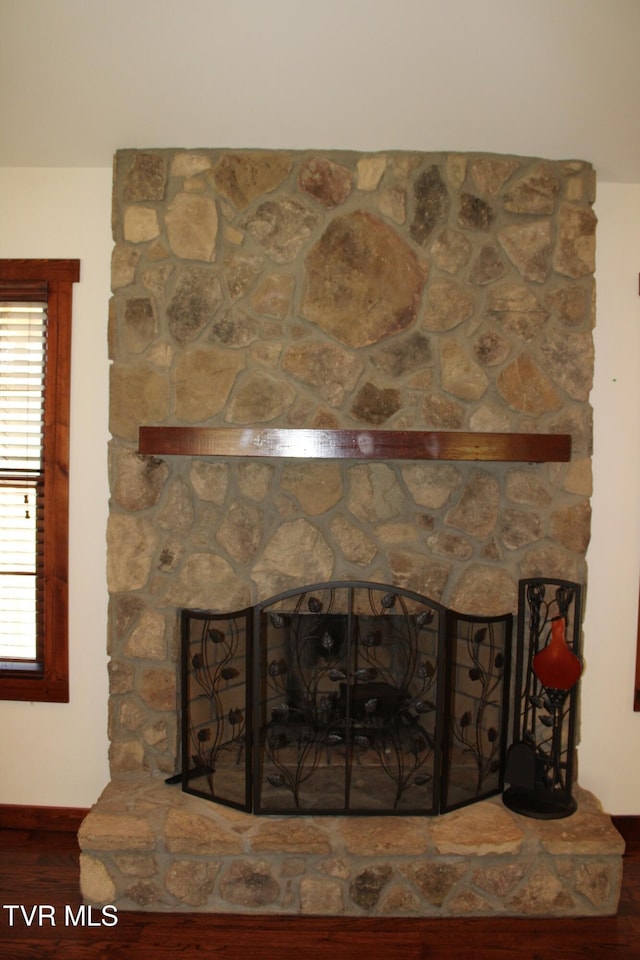 interior details featuring hardwood / wood-style flooring and a fireplace