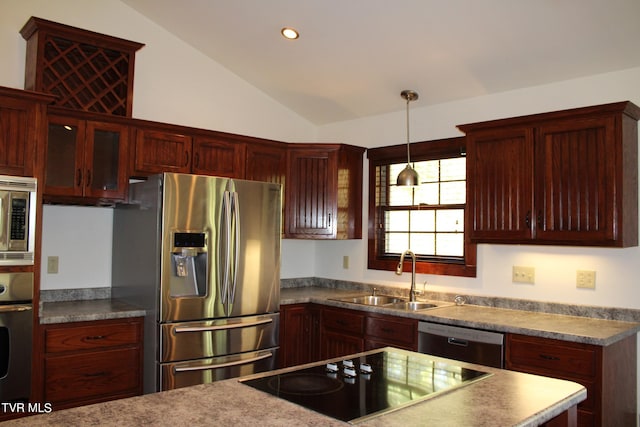 kitchen featuring stainless steel appliances, hanging light fixtures, lofted ceiling, and sink