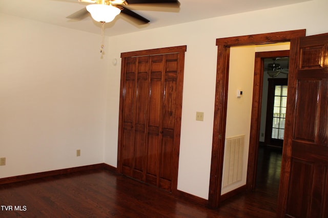 unfurnished bedroom featuring ceiling fan and dark hardwood / wood-style floors