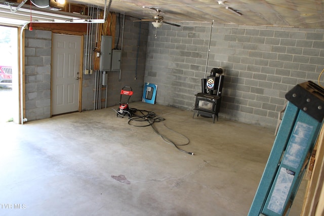 garage featuring electric panel and a wood stove