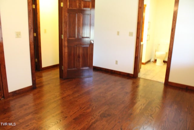 unfurnished room featuring dark hardwood / wood-style flooring