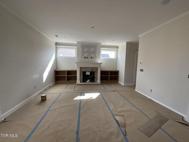 unfurnished living room featuring ornamental molding and a fireplace