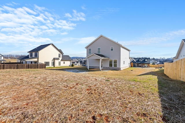 back of property with a lawn