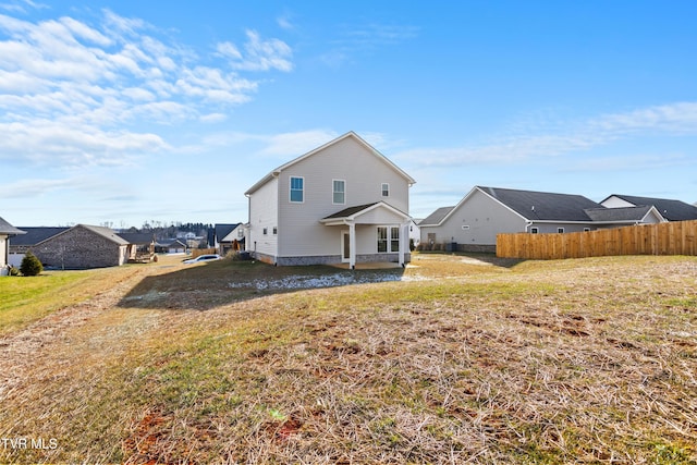 rear view of property featuring a yard