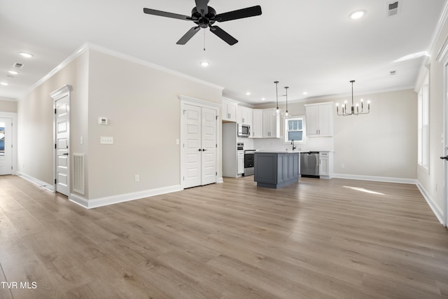 unfurnished living room with ceiling fan with notable chandelier, sink, ornamental molding, a healthy amount of sunlight, and light hardwood / wood-style flooring