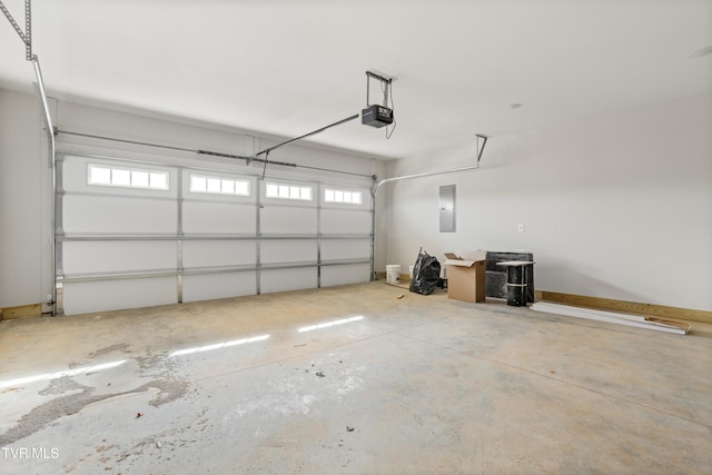 garage with a garage door opener and electric panel