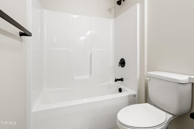 bathroom with shower / washtub combination and toilet