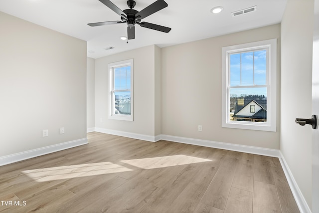 spare room with light hardwood / wood-style flooring and ceiling fan