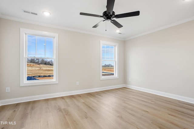 spare room with ornamental molding, light hardwood / wood-style floors, and ceiling fan