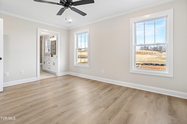 unfurnished bedroom featuring multiple windows, connected bathroom, ceiling fan, and light wood-type flooring