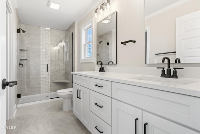 bathroom with an enclosed shower, vanity, ornamental molding, and toilet