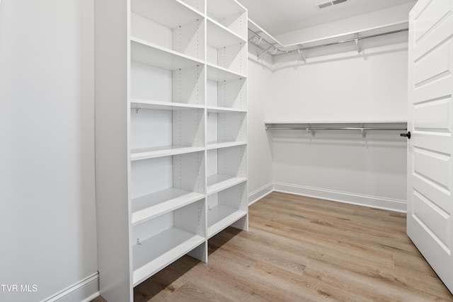 walk in closet featuring light hardwood / wood-style floors