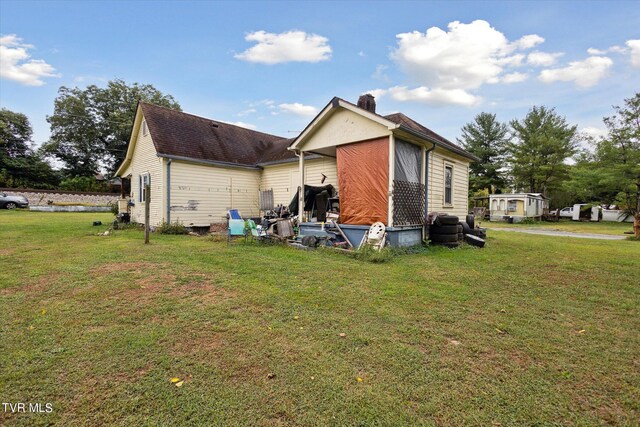 view of side of home featuring a lawn