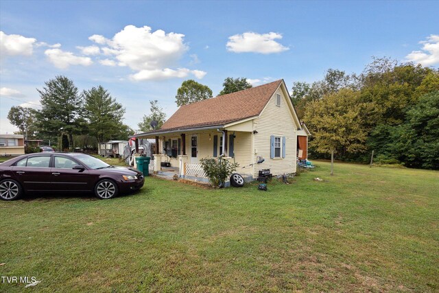 view of front of home featuring a front yard and a porch