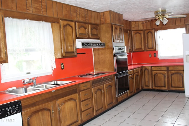 kitchen with plenty of natural light, sink, white appliances, and range hood