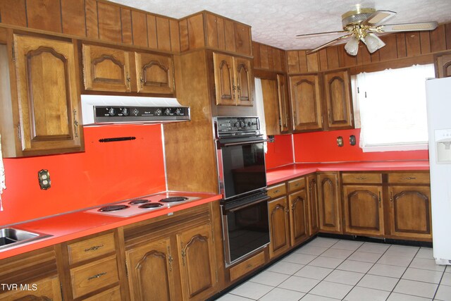 kitchen featuring ventilation hood, a textured ceiling, and white appliances