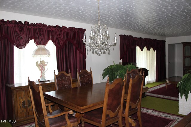 dining room with a textured ceiling and a chandelier