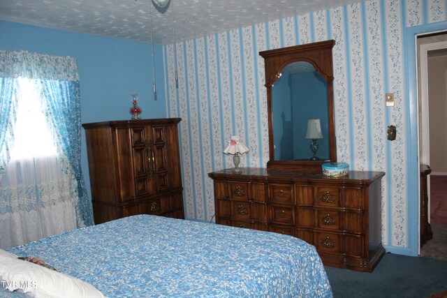 bedroom with carpet and a textured ceiling