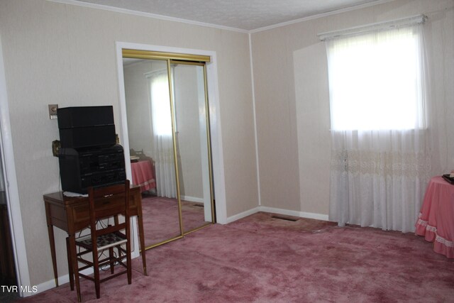 bedroom featuring a closet, carpet floors, and crown molding