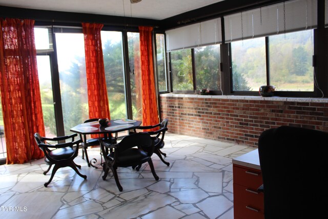 sunroom featuring a healthy amount of sunlight