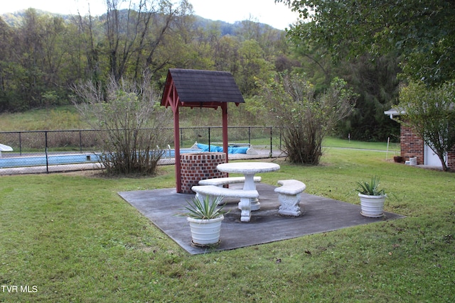 view of yard with a fenced in pool and a patio