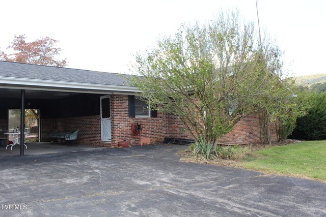 view of side of property featuring a carport